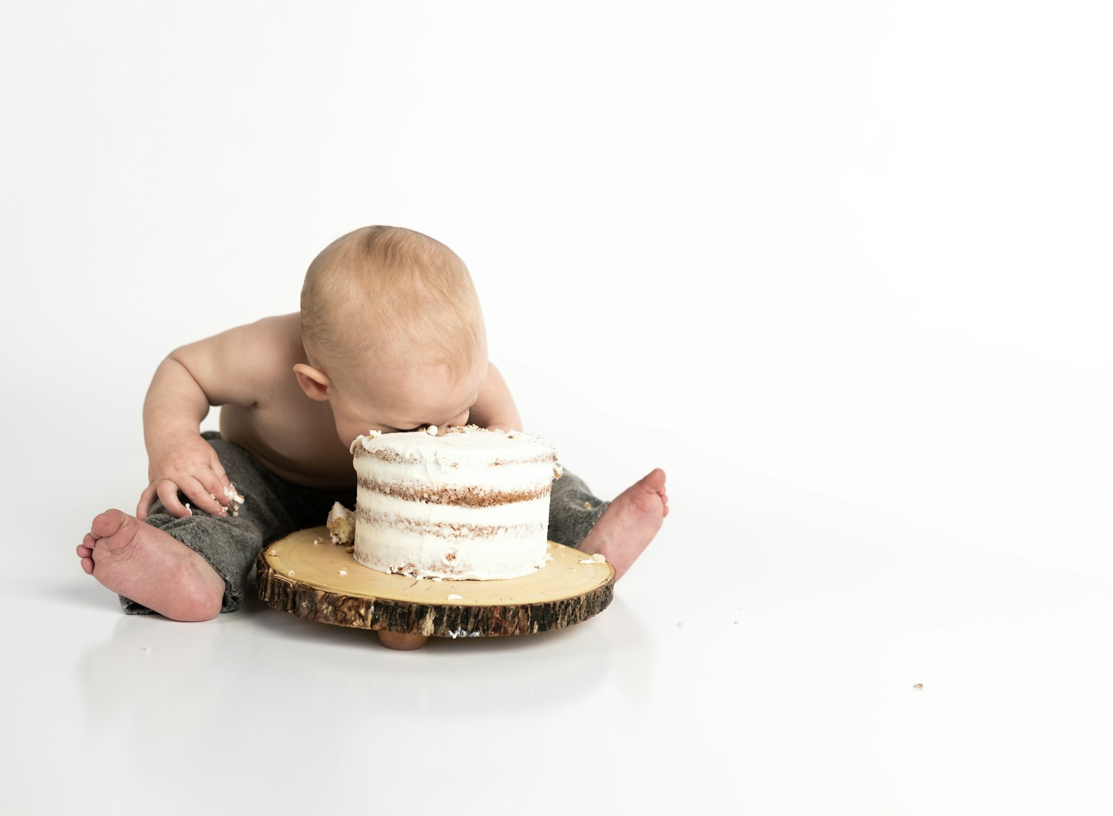 Baby enjoying a first birthday cake